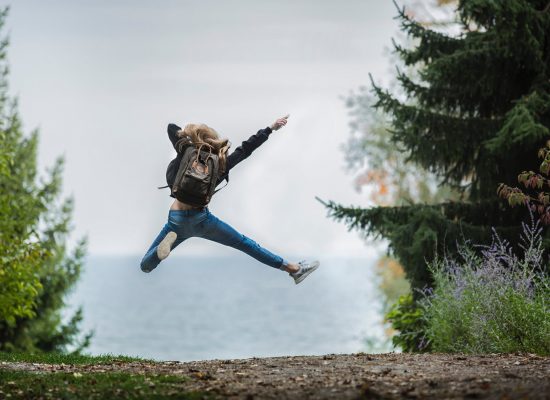 Woman jumping with joy just like clients who have shared their testimonials.